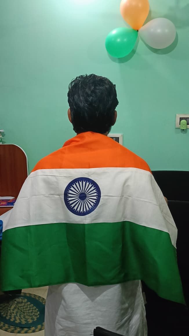 Student with the Indian flag draped over his shoulders