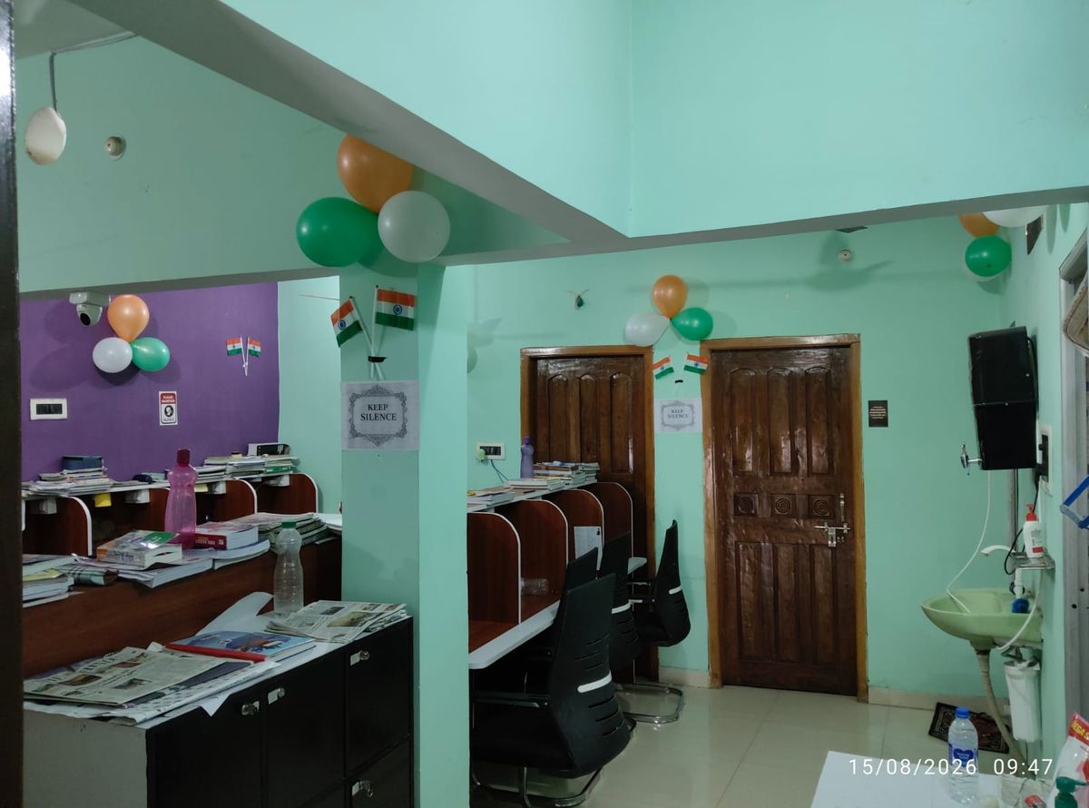 Library hall decorated with tricolour balloons and flags